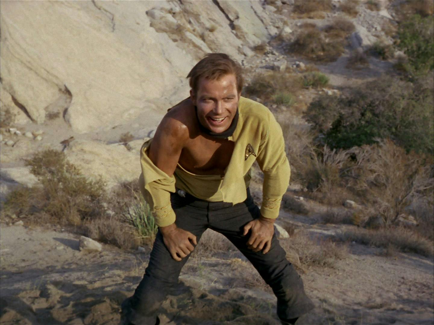 Kirk leans over as his shirt uniform is torn in 'Shore Leave'