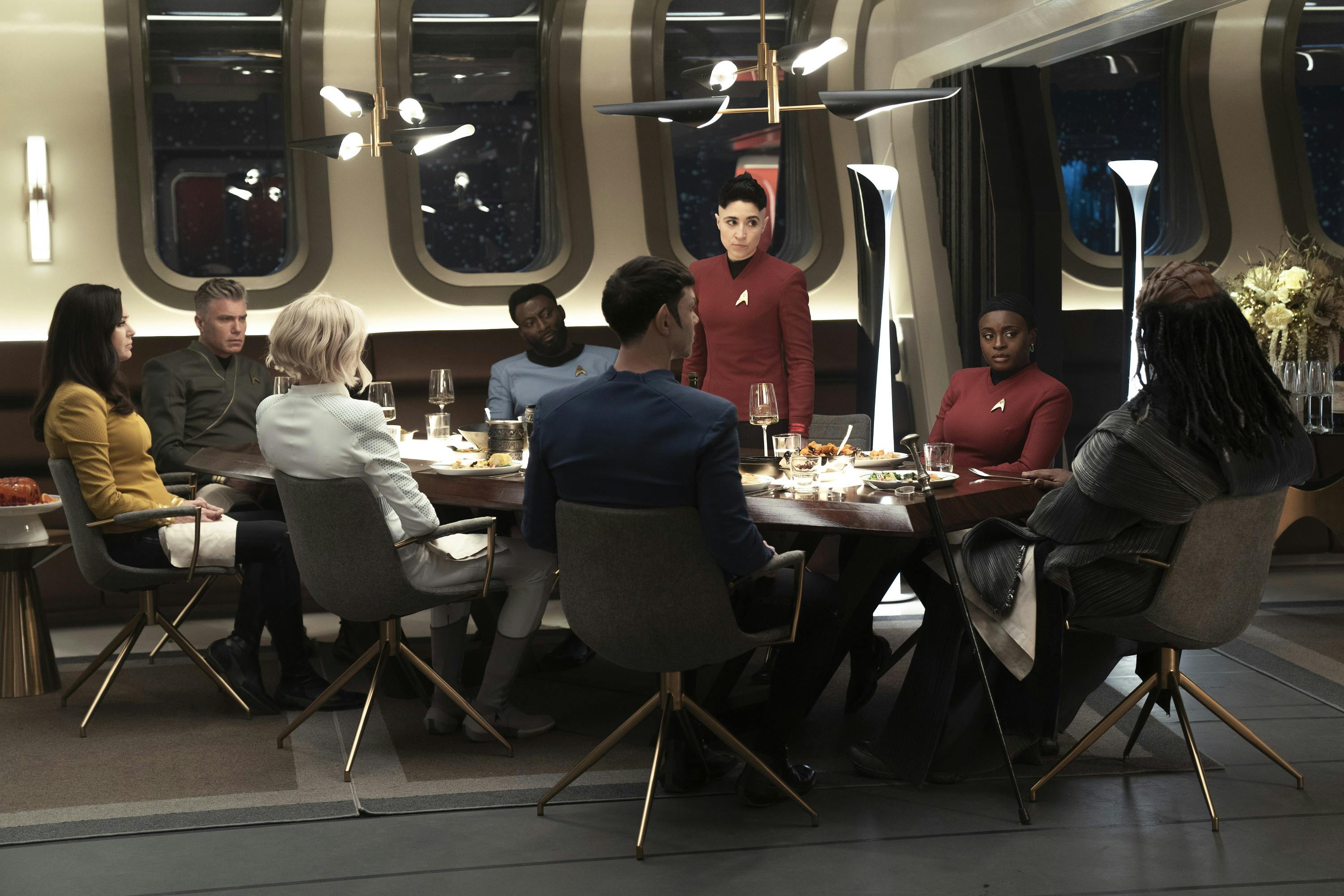 At the captain's dinner, the Enterprise crew is joined by Klingon Ambassador Dak'Rah as an incensed Erica Ortegas rises to her feet facing him in 'Under the Cloak of War'