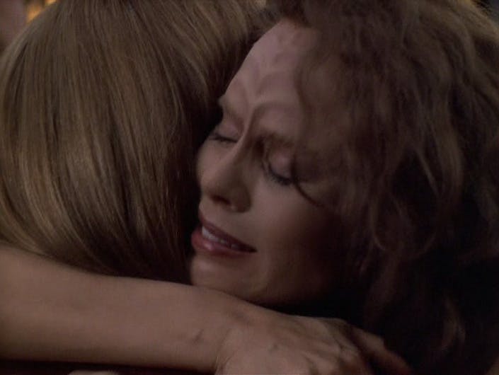 An emotional B'Elanna Torres wakes up on a biobed in Sickbay and pulls Janeway into an embrace in 'Barge of the Dead'
