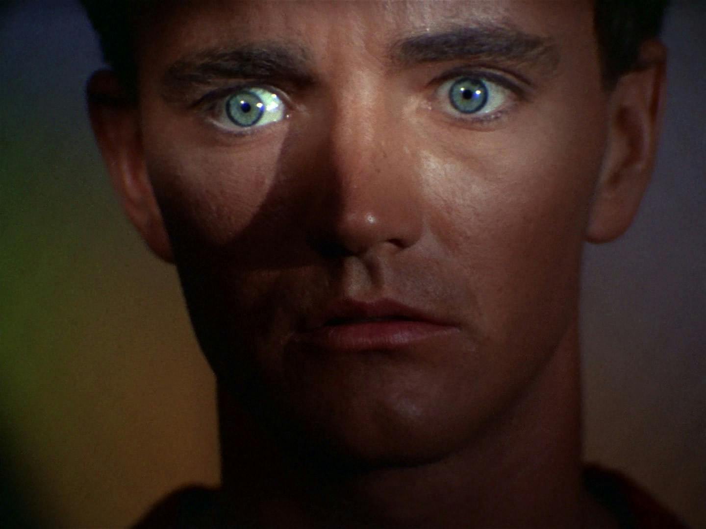 Close-up of Charlie Evans; face where a shadow is cast over him except for the focused look on his eyes in 'Charlie X'