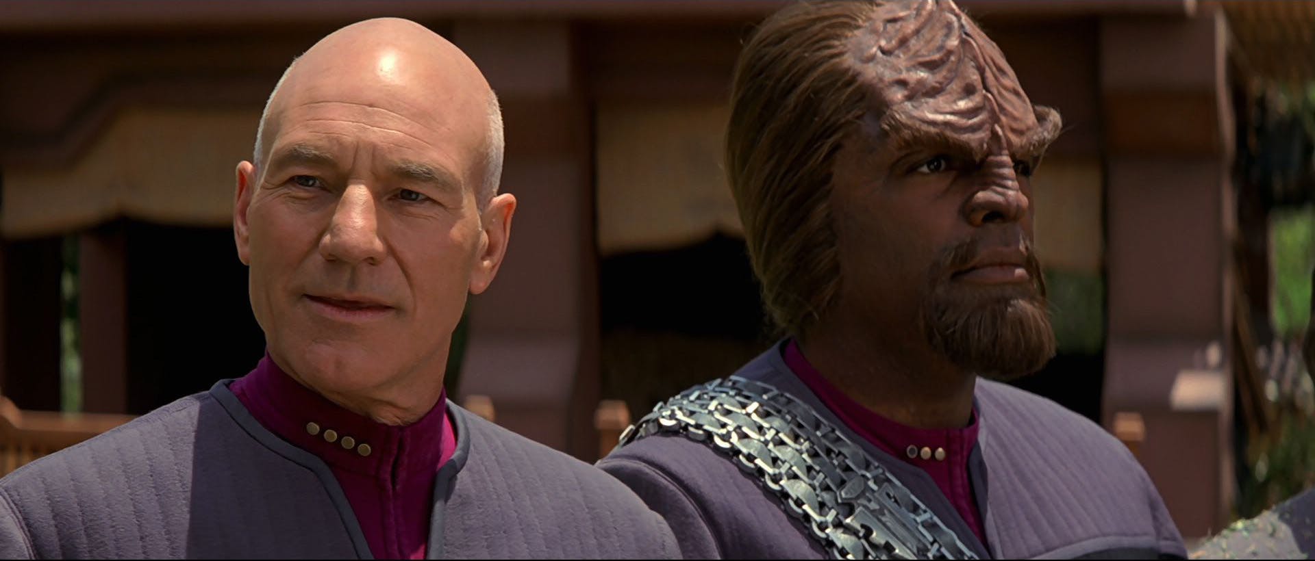 On the surface of Ba'ku, Jean-Luc Picard grins as Worf looks straight ahead in Star Trek: Insurrection