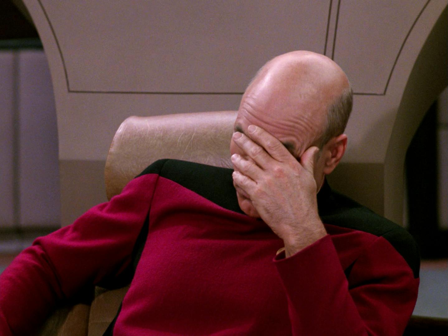 Jean Luc-Picard brings the palm of his hand to his face in reaction to Q's presence on the bridge of the Enterprise in 'Deja Q'