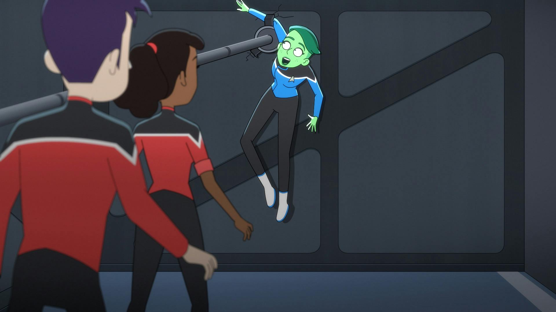 In the repair bay, Boimler and Mariner advance towards Tendi who is hanging from the wall caught by a grappling hook in 'A Few Badgeys More'