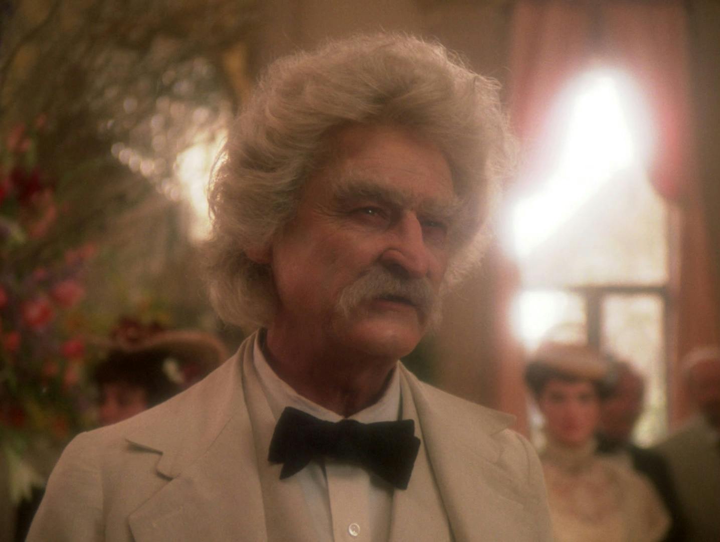Samuel Clemens aka Mark Twain holds court at a literary reception in 'Time's Arrow'