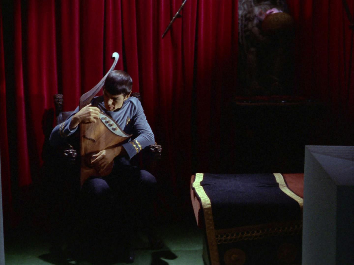 In his quarters, Spock sits in his chair and plays the lute for some comfort in 'Amok Time'
