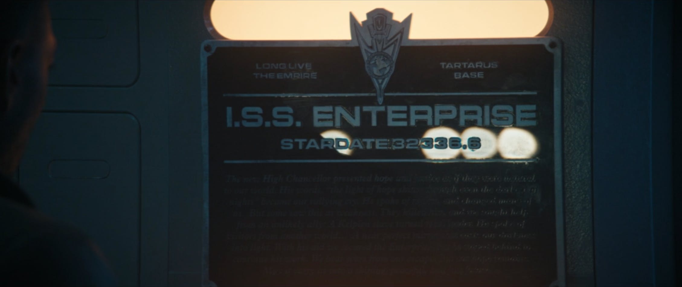 Book reads the I.S.S. Enterprise plaque in 'Mirrors'