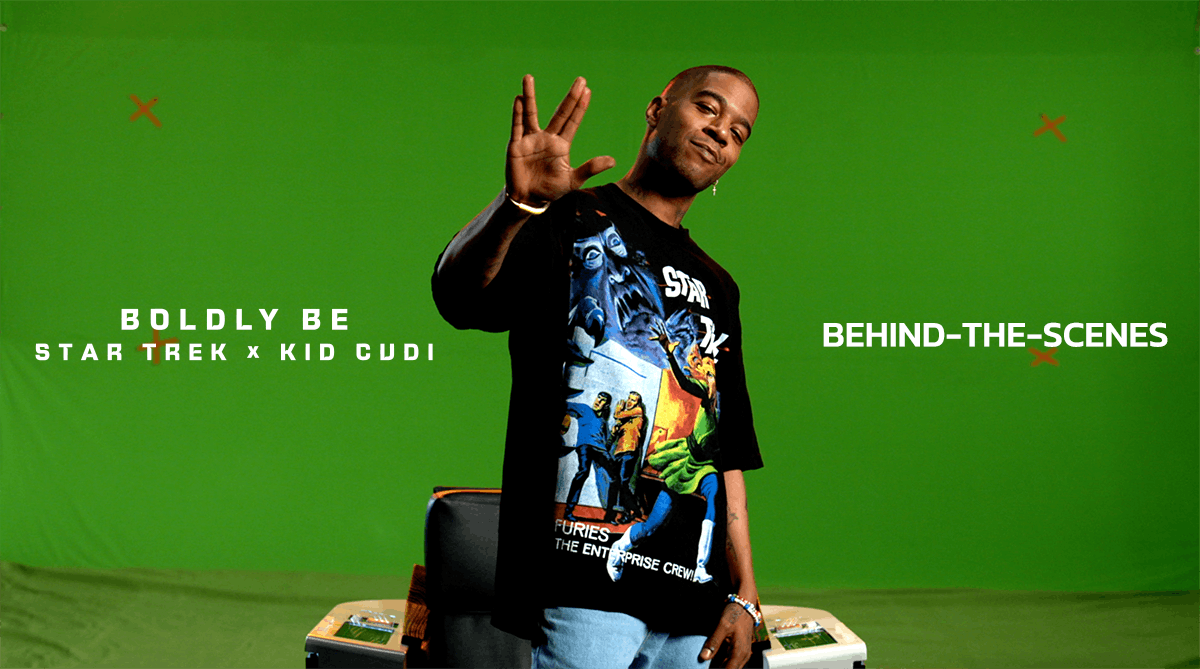 Behind the scenes still of Kid Cudi in front of the captains chair and green screen flashing the Vulcan hand
