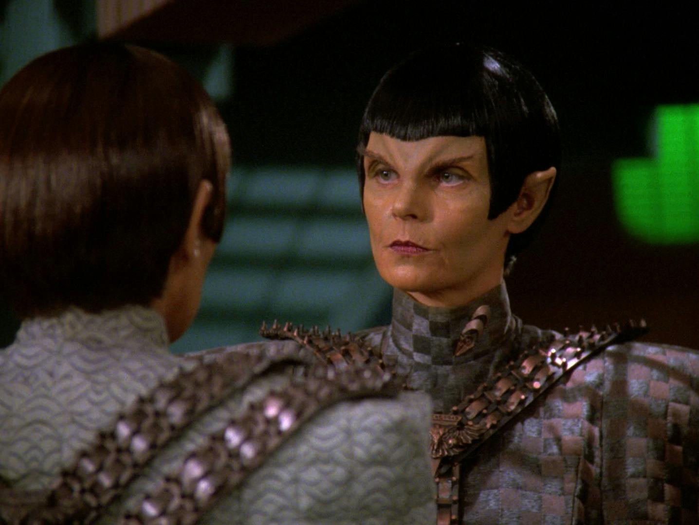 Deanna Troi posing as Major Rakal of the Tal Shiar verbally spars with Commander Toreth aboard the Romulan warbird Khazara in 'Face of the Enemy'