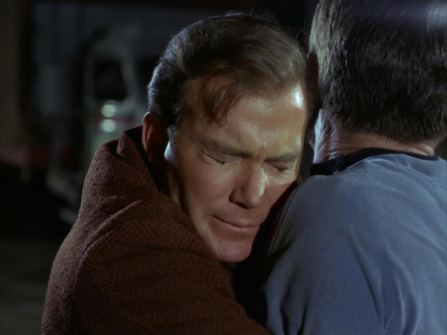 Torn with the mission to restore the timeline and saving one of his great loves, James Kirk closes his eyes as he holds Bones McCoy from helping Edith Keeler as she's about to be hit and killed by a large oncoming truck in 'The City on the Edge of Forever'