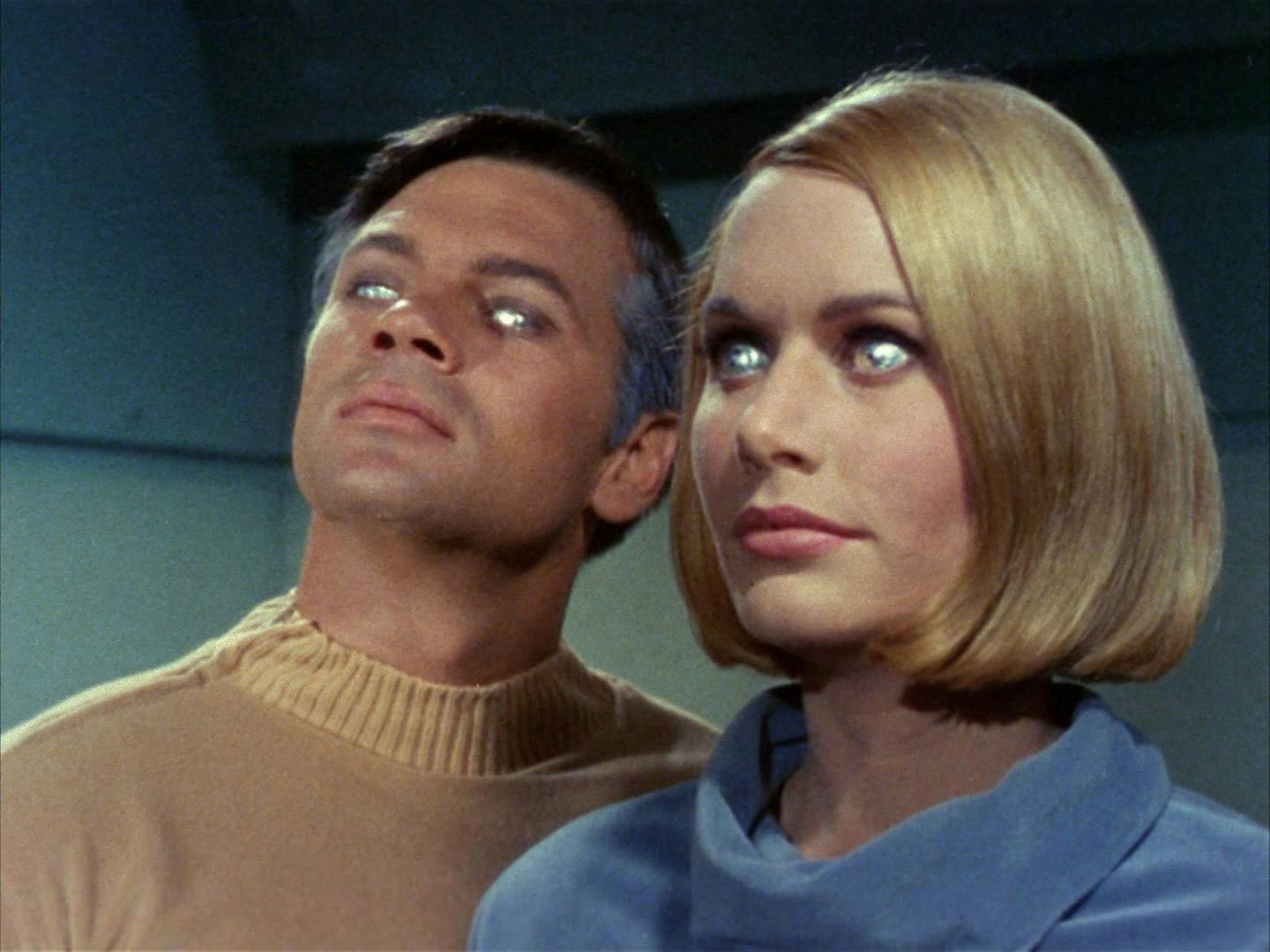 Close-up of Gary Mitchell and Dr. Elizabeth Dehner, both affected by galactic barrier, developed ESP abilities as shown by their silver eyes in 'Where No Man Has Gone Before'