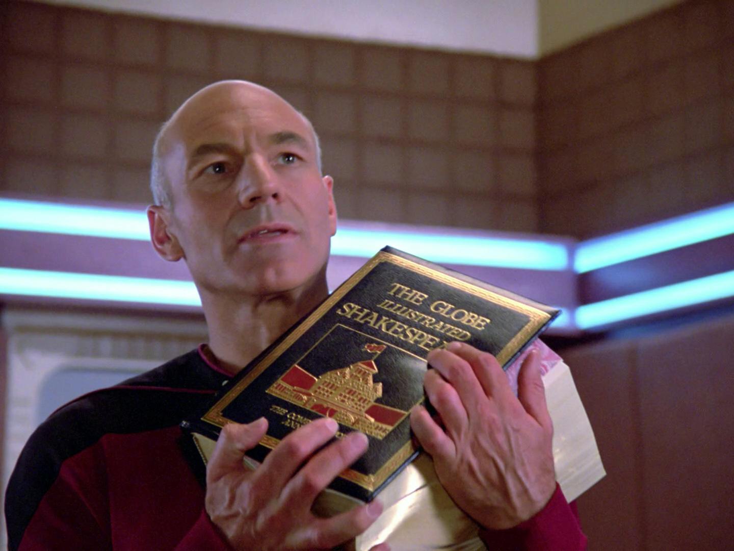 Standing in his ready room, Jean-Luc Picard lifts his copy of 'The Globe Illustrated Shakespeare' in 'Hide and Q'