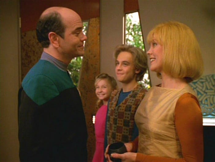 Greeting him in his home on the holodeck, The Doctor gazes lovingly at his wife while he two kids both look up to him in 'Real Life'