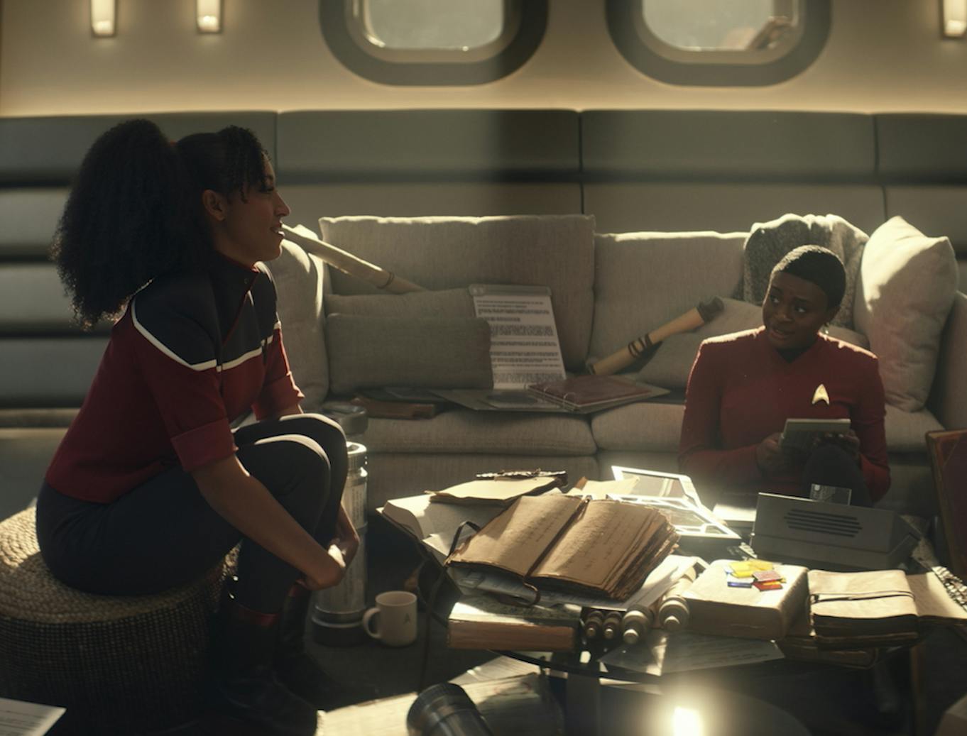 While Uhura holds a PADD in hand, surrounded by her research, Mariner watches over admiring her idol in 'Those Old Scientists'