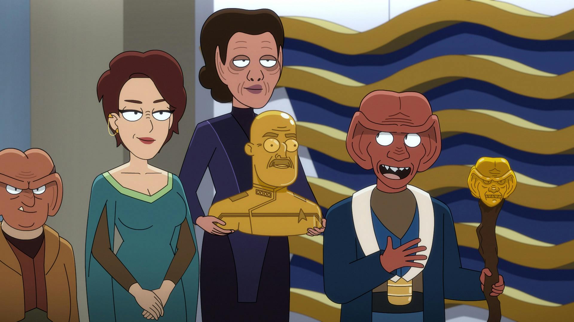 Aboard the U.S.S. Toronto, Grand Nagus Rom holding the Grand Nagus staff presents a golden bust of Admiral Vassery held by a Hupyrian servant as First Clerk Leeta stands between her and their Ferengi assistant in 'Parth Ferengi's Heart Place'