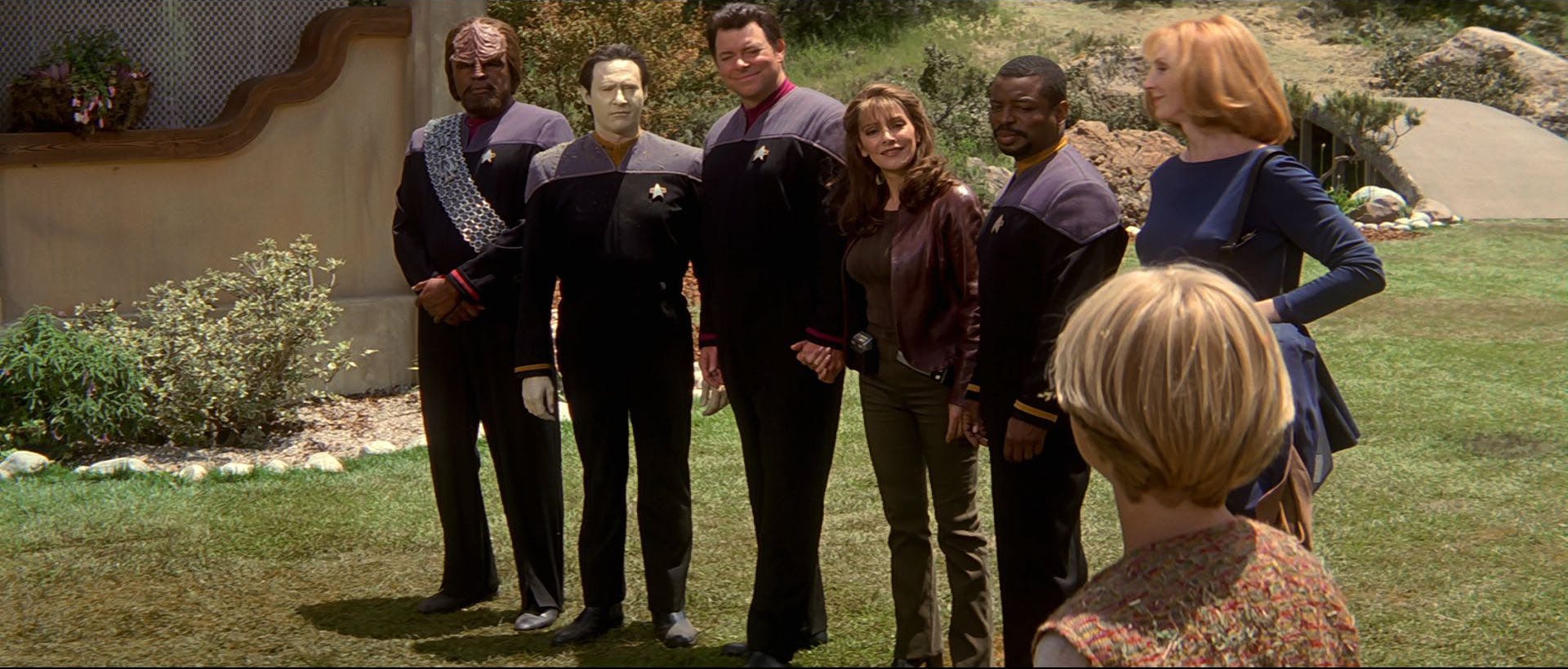 On the surface of Ba'ku, Worf, Data, Will Riker holding hands with Deanna Troi, Geordi La Forge, and Beverly Crusher admiral the locals in Star Trek: Insurrection