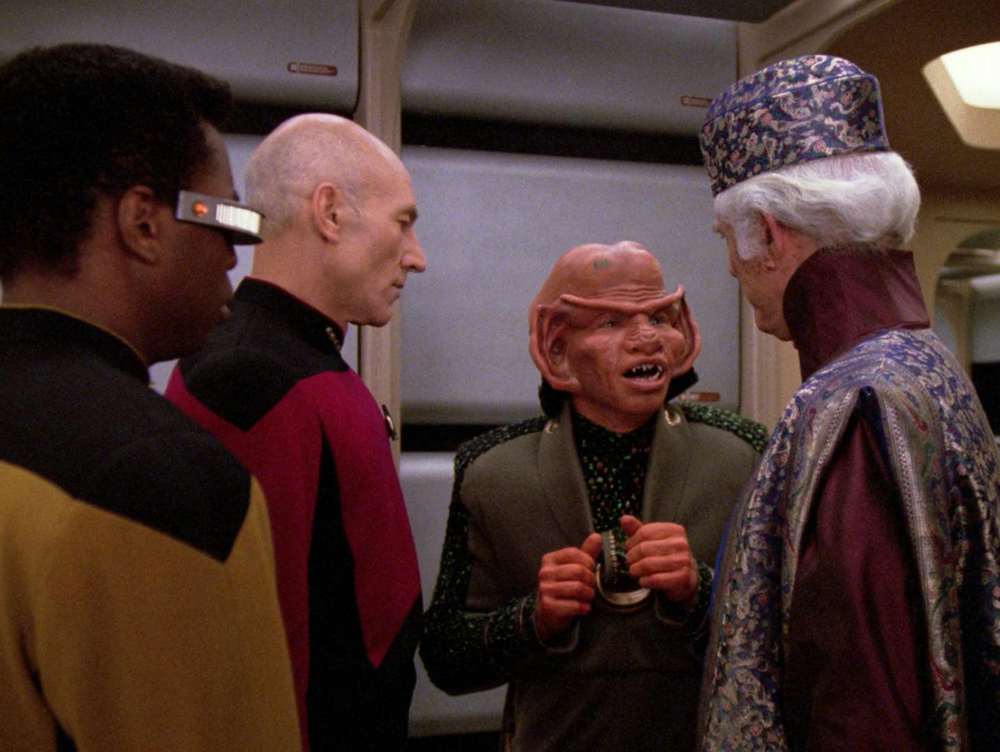 Captain Picard observes as a Ferengi introduces himself to Ambassador Briam in the Enterprise-D hallway in 'The Perfect Mate'