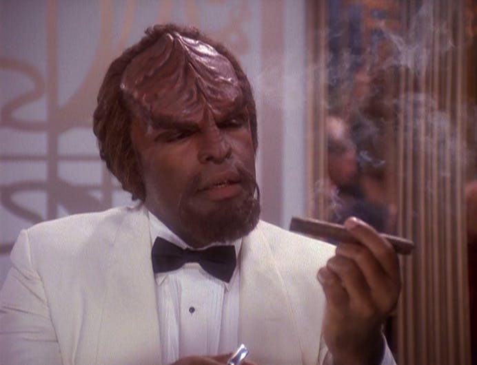 In a holosuite program, Worf appears in a white tuxedo staring at a cigar he just lit in 'Our Man Bashir'