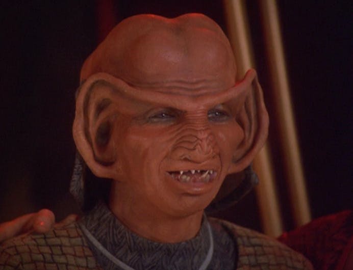 A close-up of a stunned Rom upon learning he has been chosen as the next Grand Nagus in 'The Dogs of War'