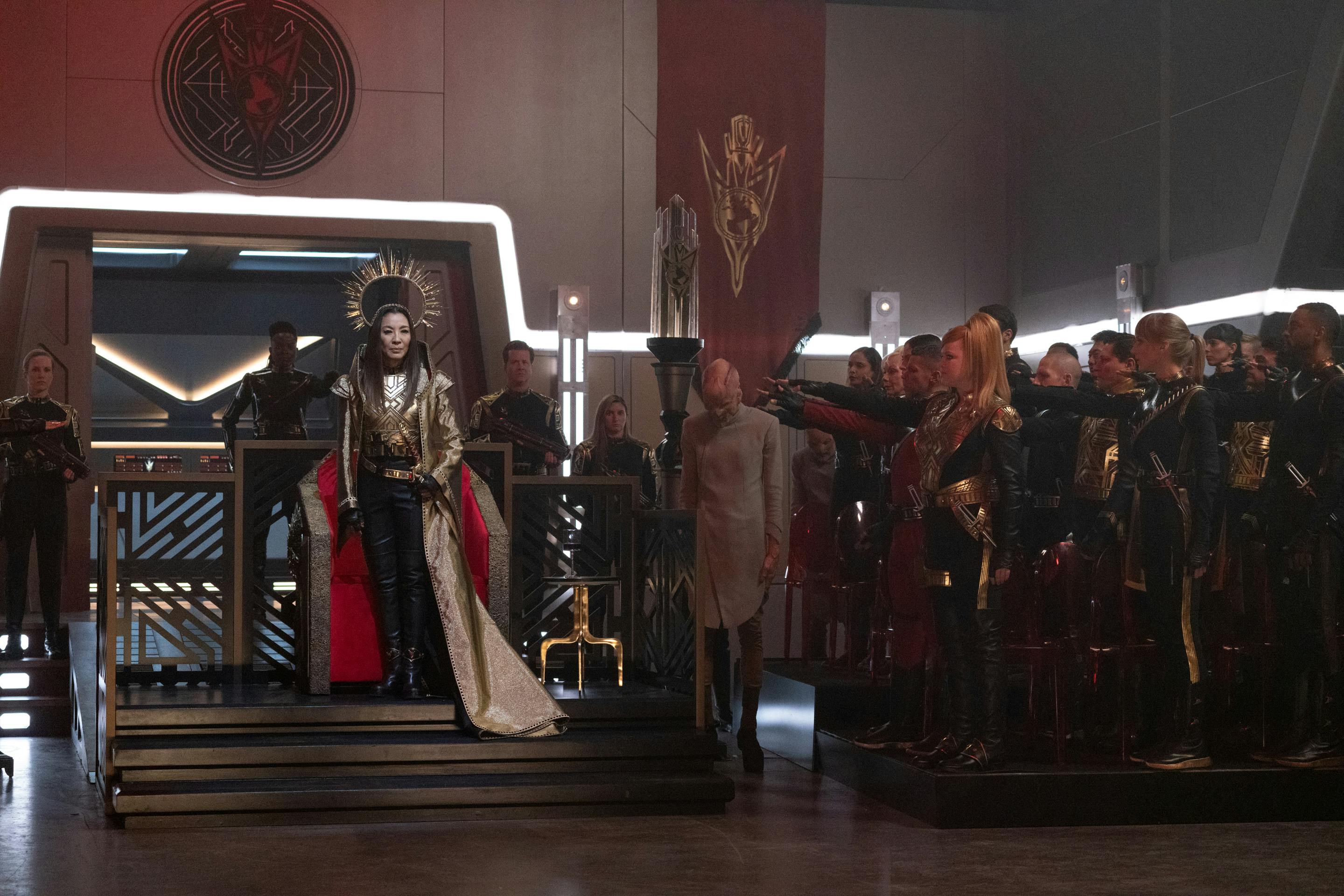 Emperor Georgiou at her throne in the Terran Empire with her loyalists raising their arms out in a Roman salute in 'Terra Firma, Part 1'