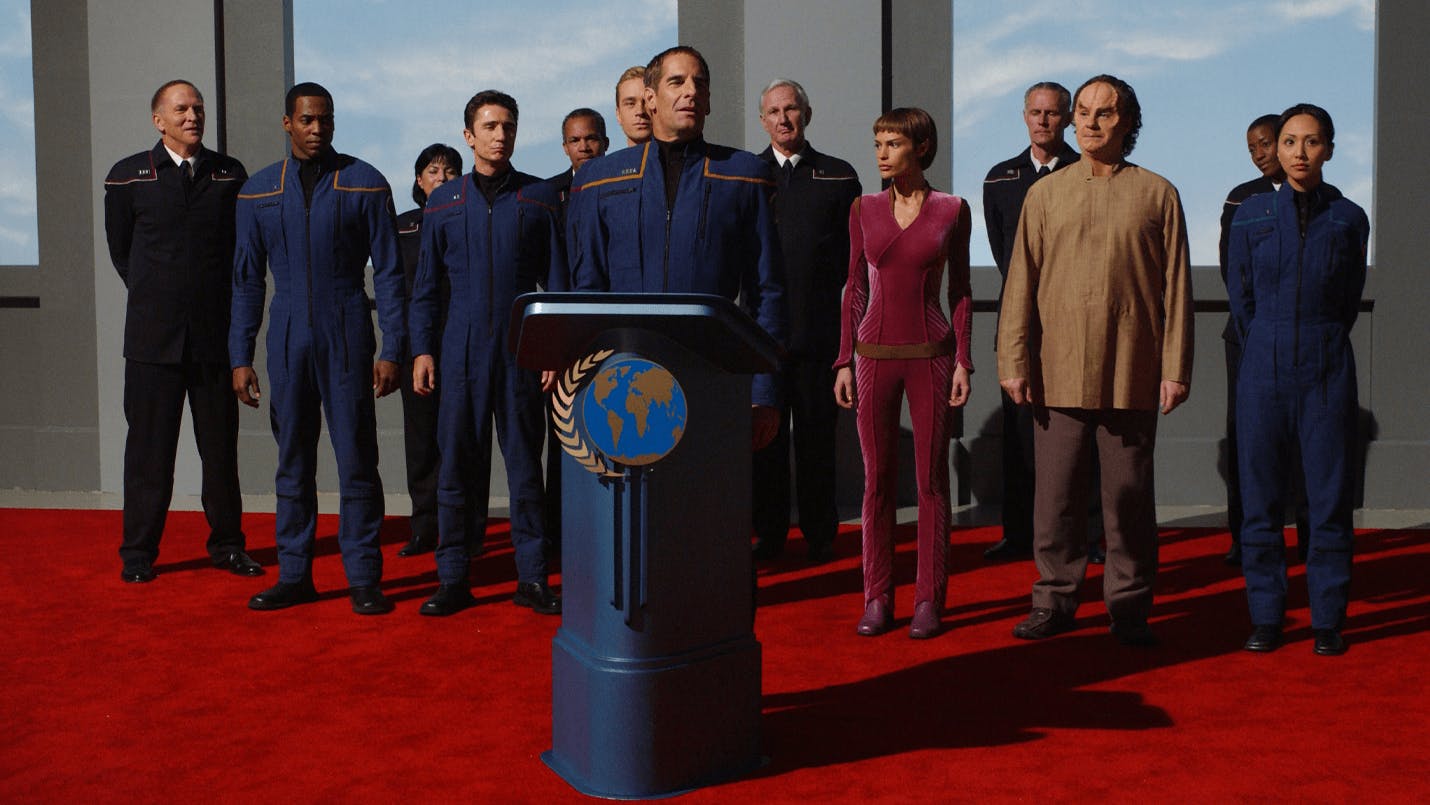 Header image for Star Trek: Enterprise showing Captain Archer at a podium, on stage with others 