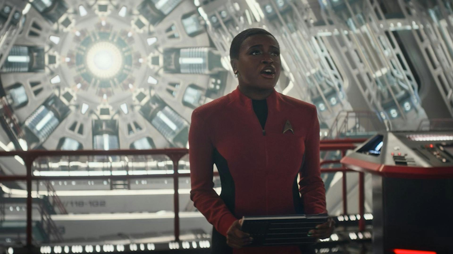 In Engineering, Uhura holds her PADD as music is transmitted towards the subspace fold in 'Subspace Rhapsody'