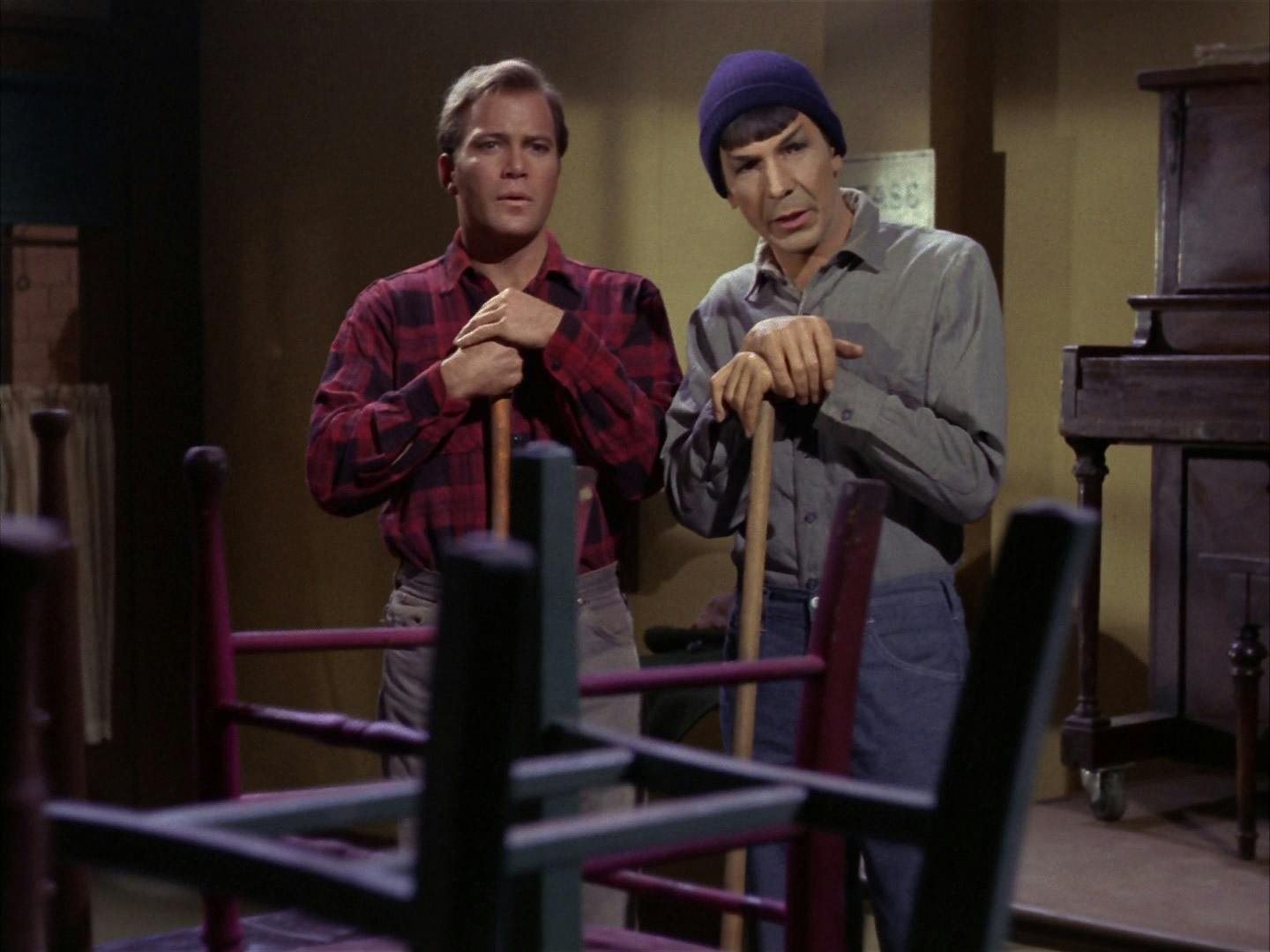 Kirk and Spock in civilian Earth clothes pause on a couple brooms in 'The City on the Edge of Forever'