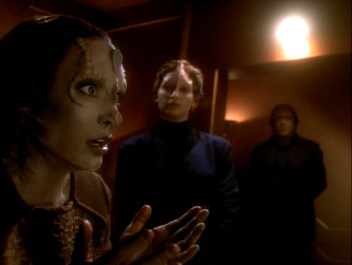 Major Kira Nerys expresses horror upon discovering she was altered to look like her enemy while in the presence of two Cardassians in 'Second Skin'