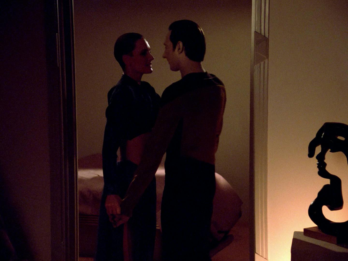 Data stands face-to-face with a lustful Tasha Yar in the doorway of her quarters in 'The Naked Now'