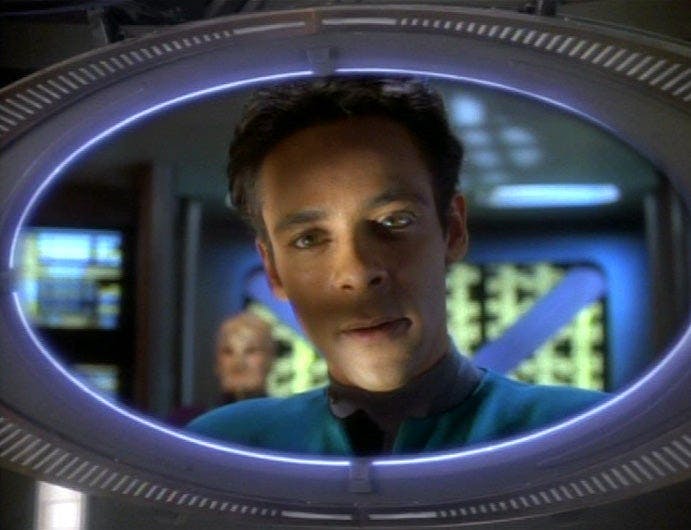 Dr. Bashir, possessed by an alien, talks to the crew via the DS9 ops viewscreen.
