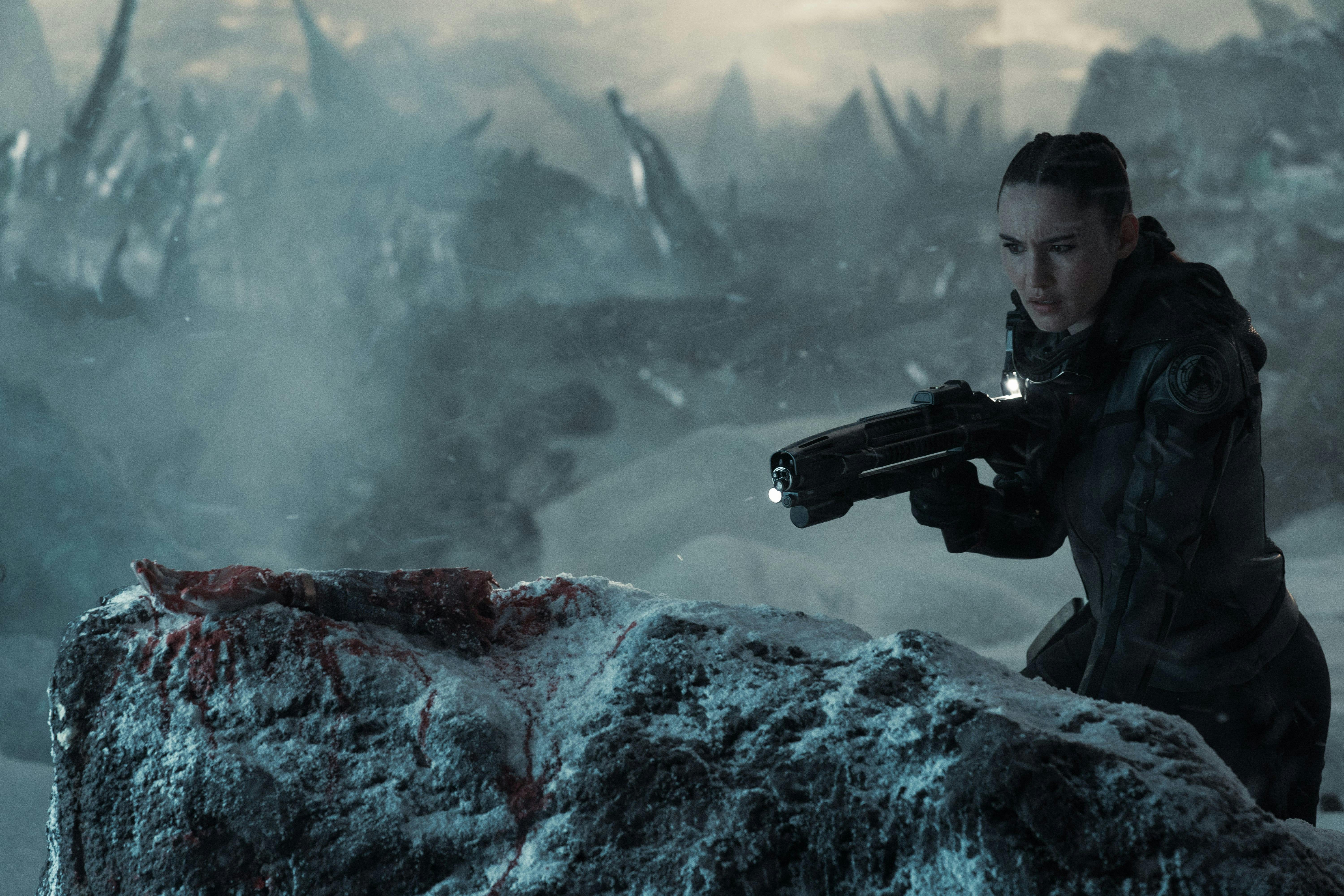 La'An (Christina Chong) takes aim with her phaser rifle on a snowy planet.