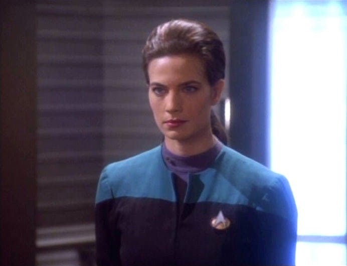 Dax in an official stance with a serious expression on Deep Space Nine