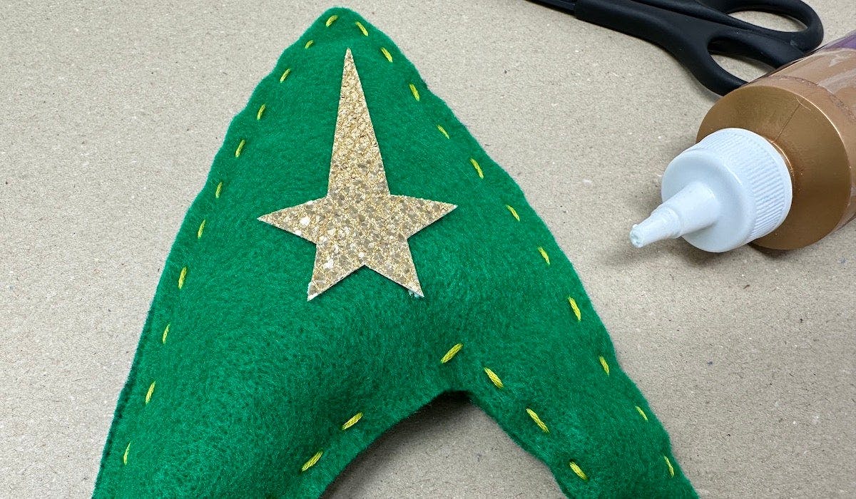 Starfleet Insignia Holiday Craft by Kelly Knox - Cut the traced template on Starfleet insignia star on a gold felt and glue onto green felt