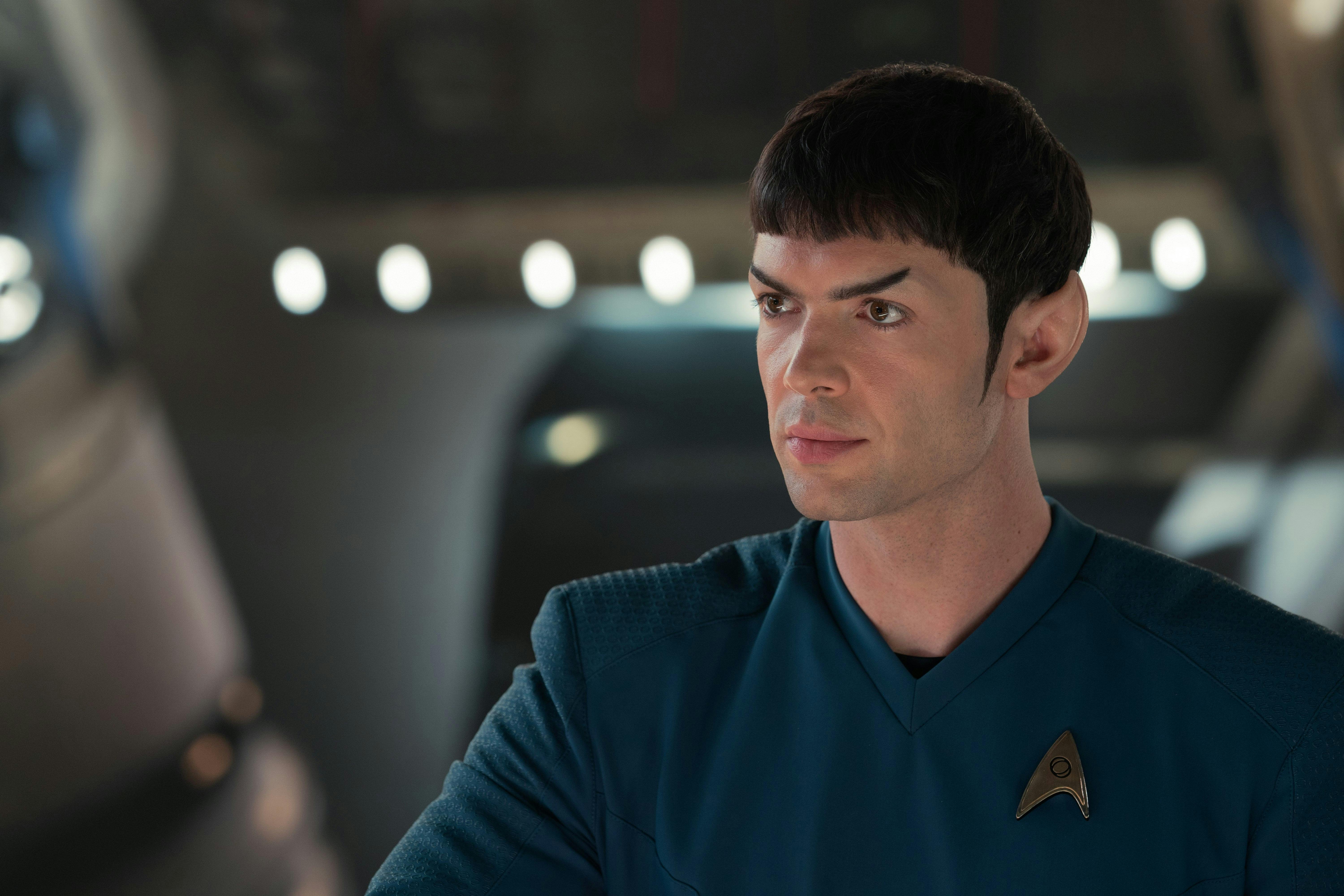 Spock (Strange New Worlds) is sitting at an unknown location. He is looking to the right side of the image.