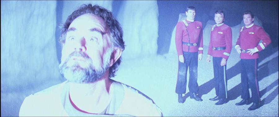 Sybok looks at the deity as Spock, McCoy, and Kirk stand in the back on Star Trek: The Final Frontier