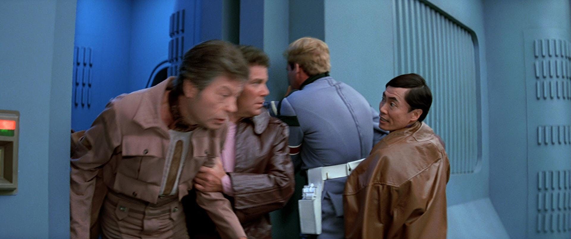 Sulu holds a guard in place as Kirk rescues McCoy from his holding cell in The Search for Spock