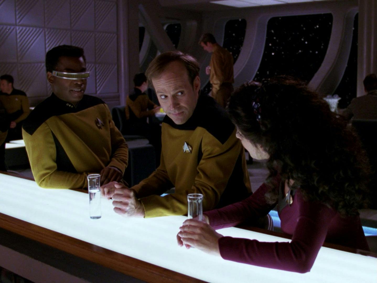 Geordi La Forge, Barclay, and Deanna Troi enjoy drinks at 10 Forward in 'The Nth Degree'