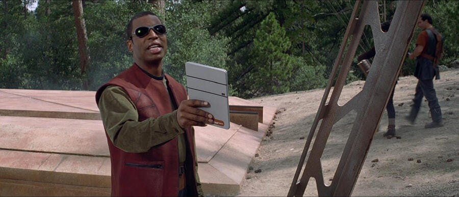 Wearing shades and civilian clothing, Geordi lifts up his PADD on the surface of Earth in Bozeman in Star Trek: First Contact