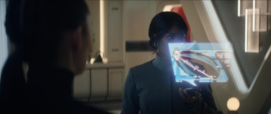 Agent Ymalay pulls up a timeline hologram from a device in 'Tomorrow and Tomorrow and Tomorrow'