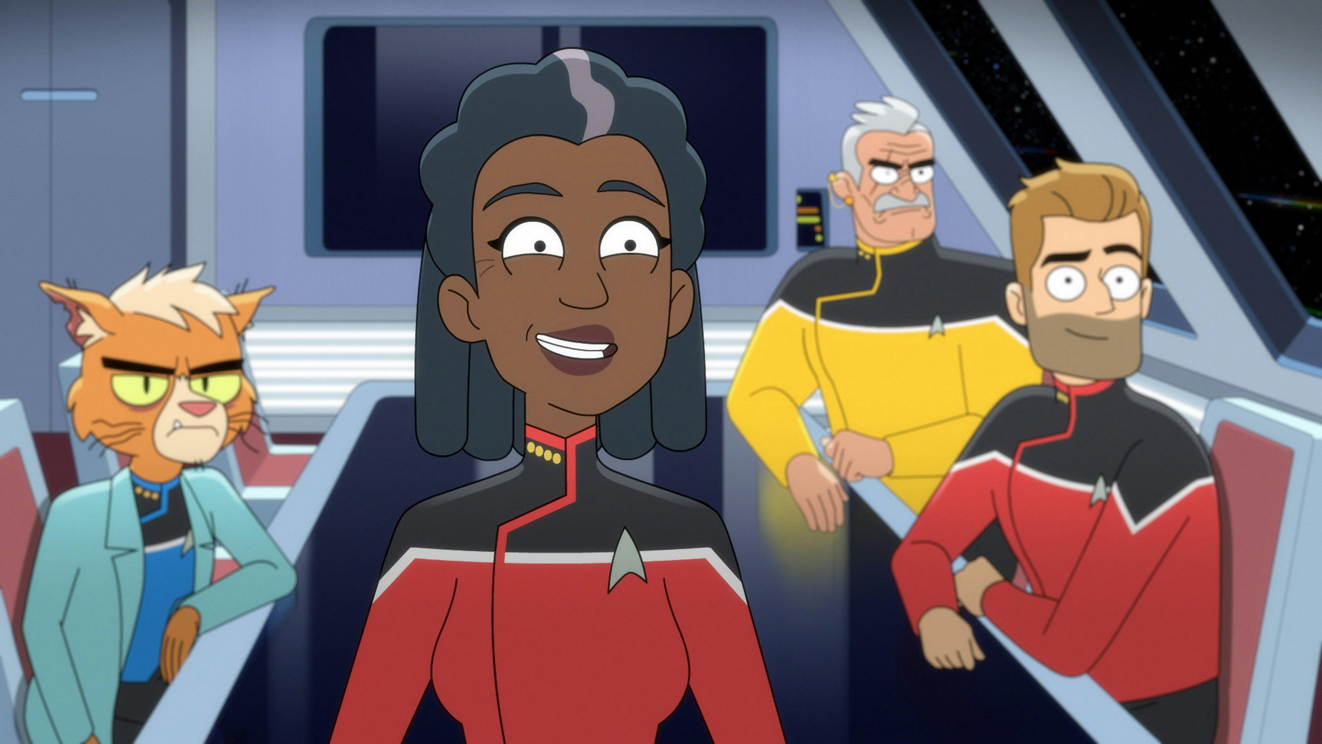Captain Freeman smiles. Dr. T'Ana, Lt. Shaxs, and Commander Ransom sit behind her.