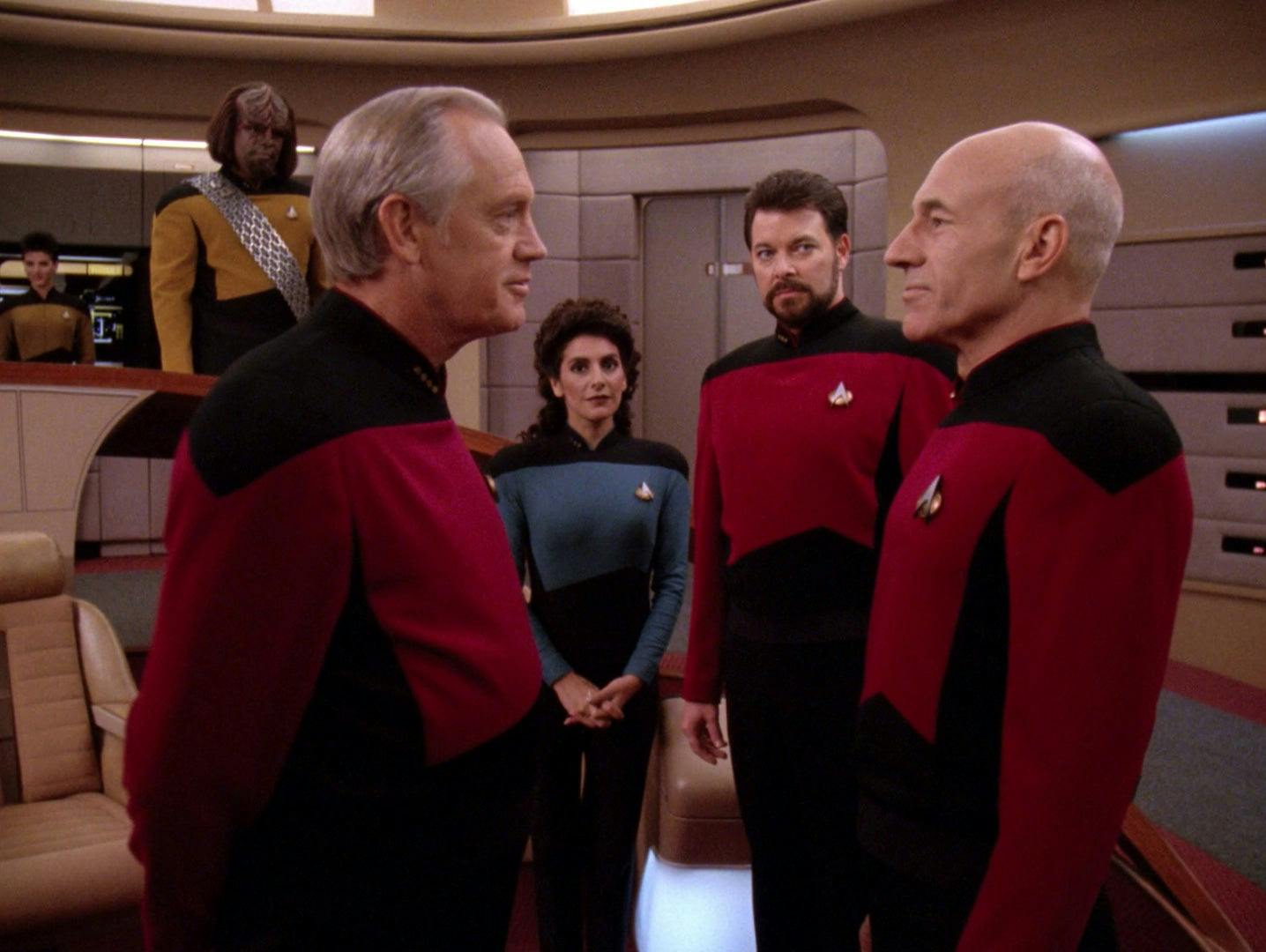 On the Bridge of the Enterprise, Jellico and Picard stand face to face as Troi and Riker look at them on Star Trek: The Next Generation