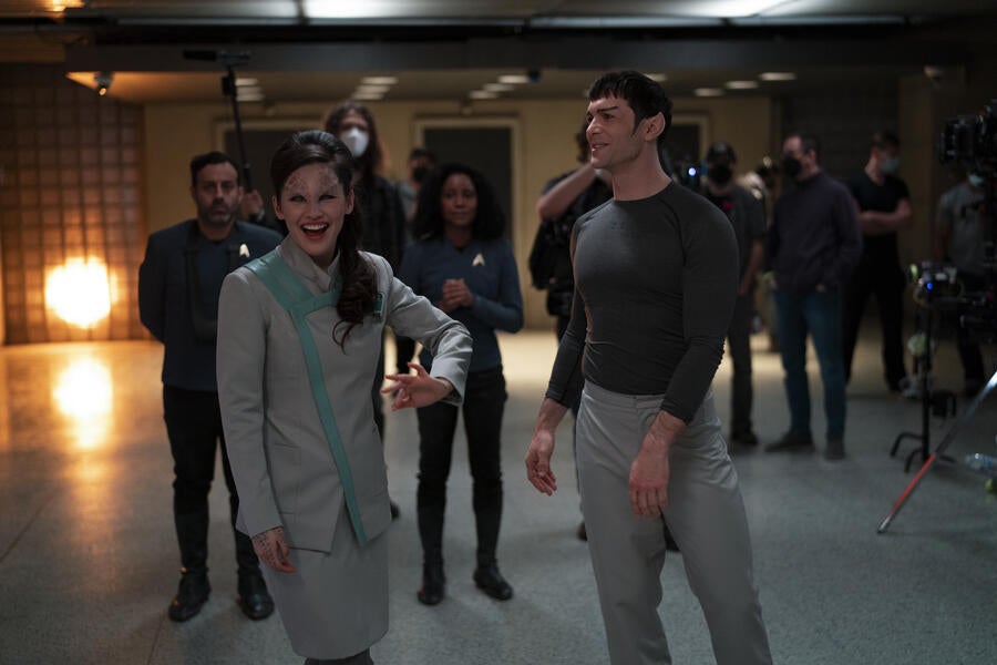 Christina Chong and Ethan Peck laugh between takes.