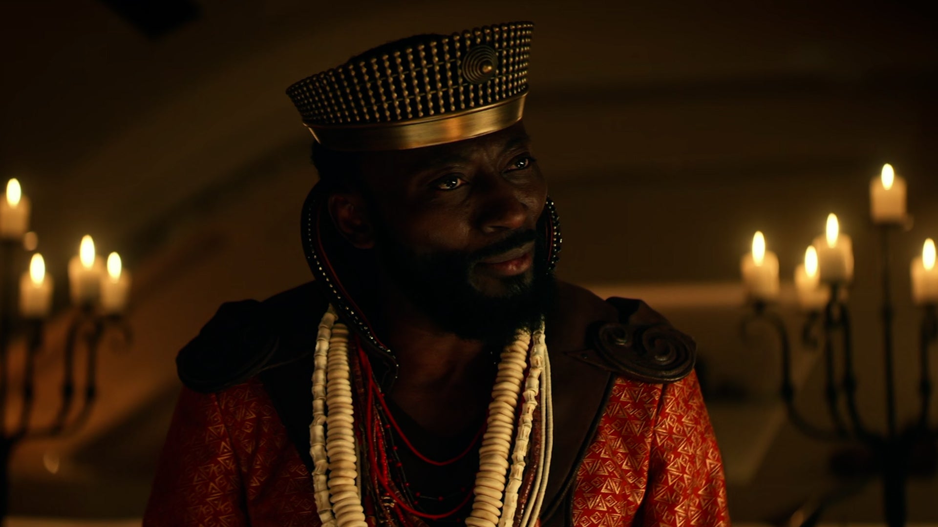 Dr. M'Benga (Babs Olusanmokun), wearing a crown and robes, looks confused at the new events on the Enterprise.