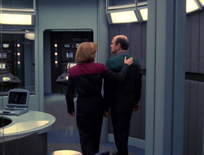Janeway and the Doctor walk away as she puts his hand on his back shoulder in 'Renaissance Man'
