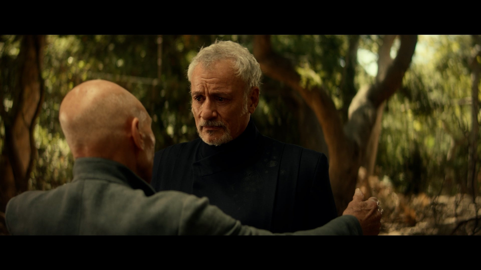 Jean-Luc approaching Q, getting ready to hug him. 