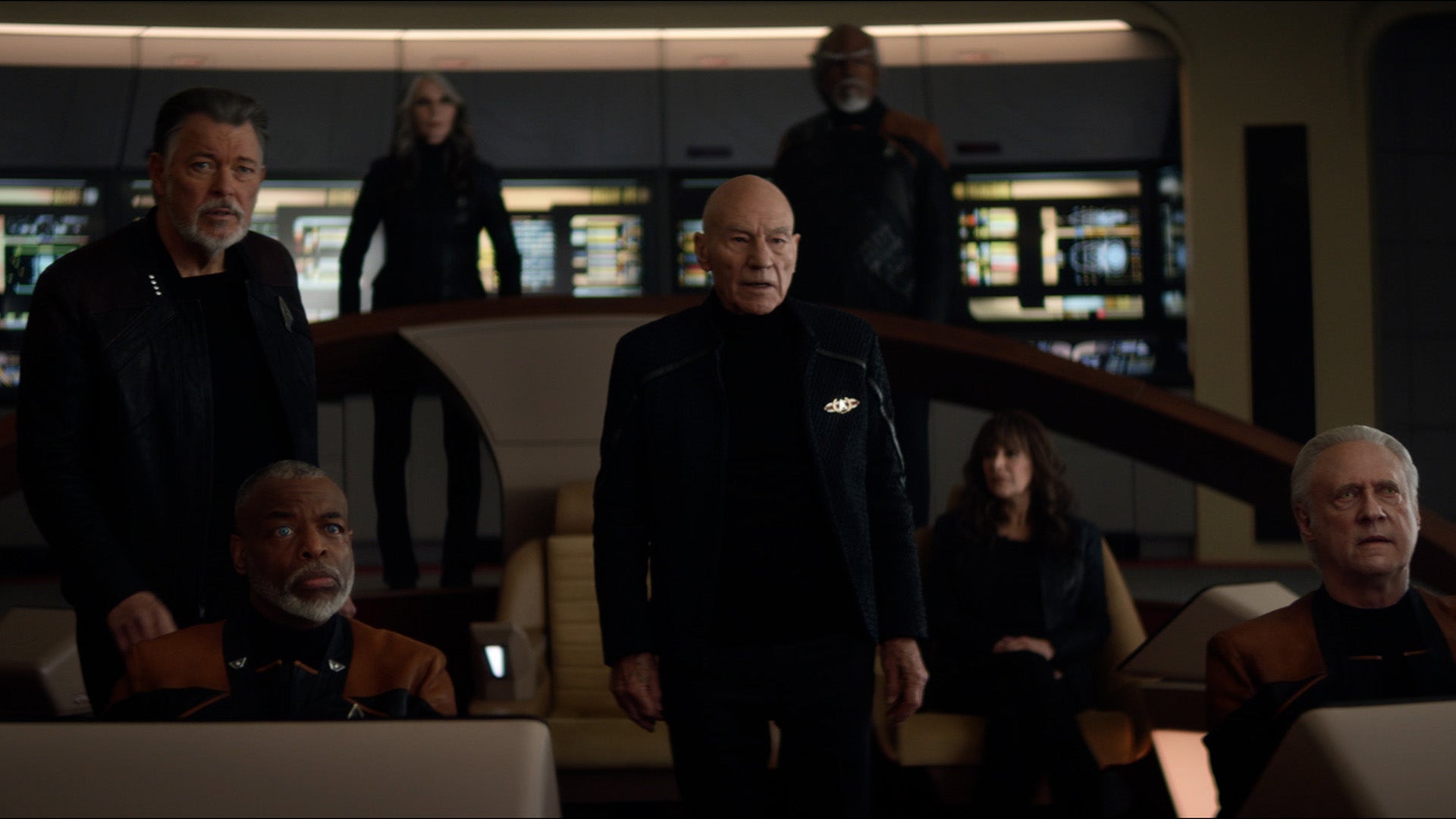The Next Gen crew aboard the reconstructed U.S.S. Enterprise-D looking intensely at what's on the viewscreen ahead of them in 'The Last Generation'