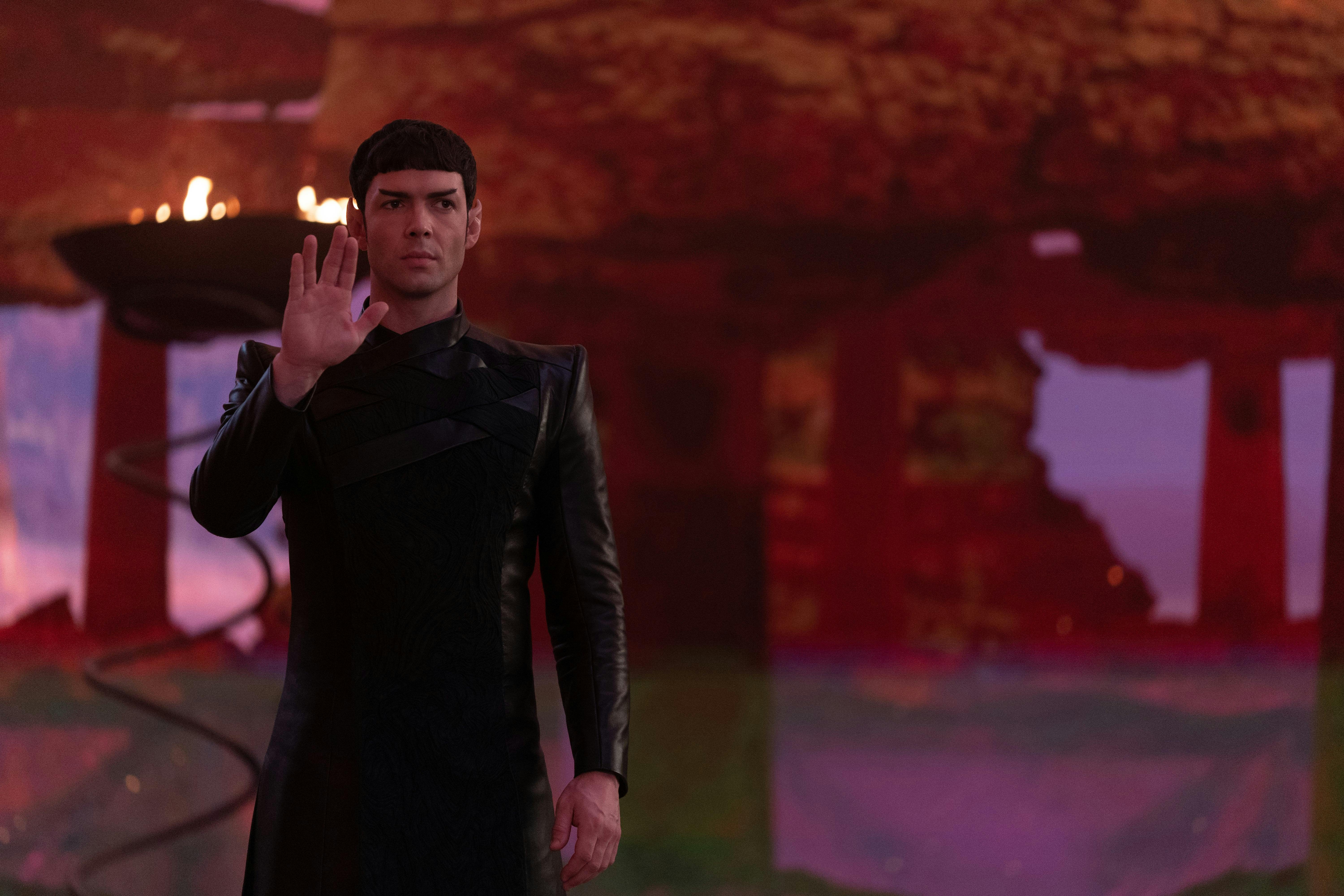 Spock (Strange New Worlds) has his hand raised in the Live Long and Prosper gesture.