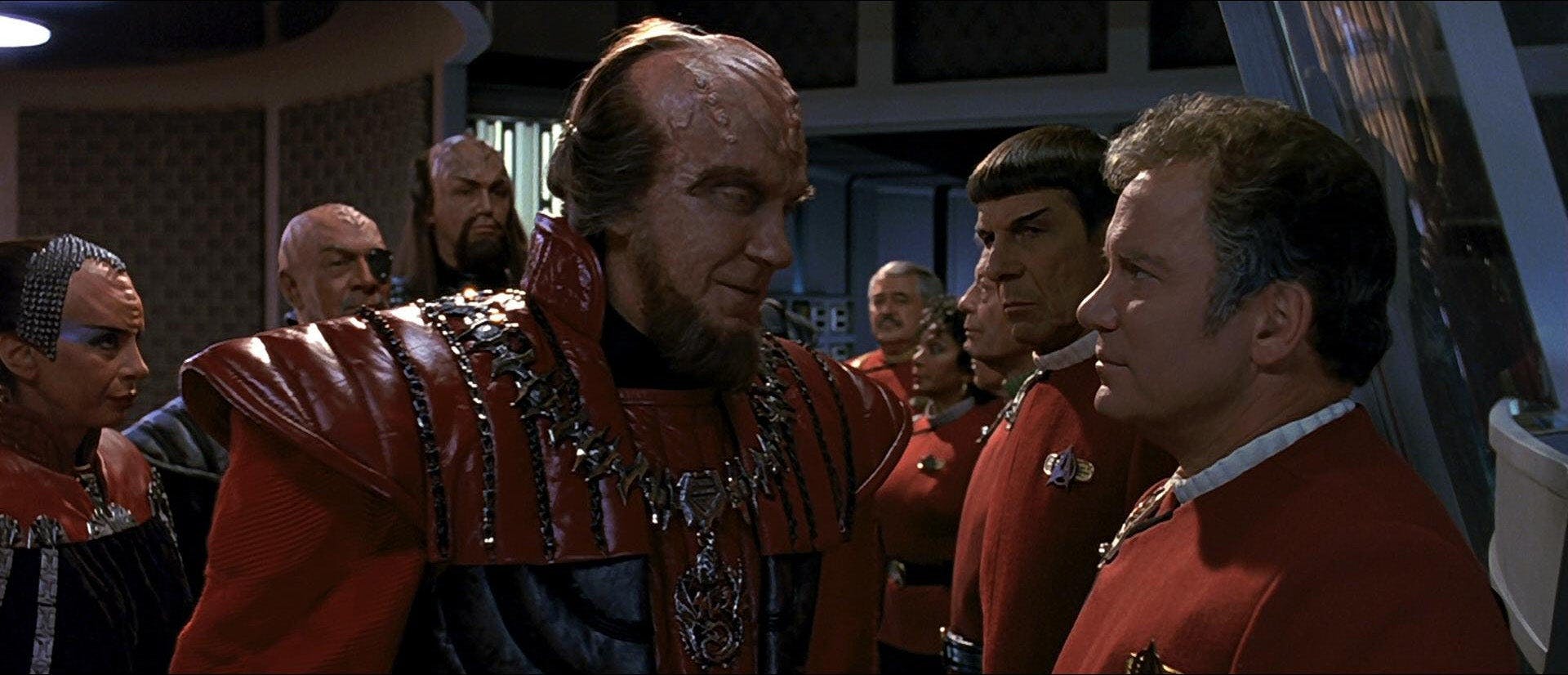 Chancellor Gorkon stands face-to-face with Kirk among their crews in Star Trek VI: The Undiscovered Country