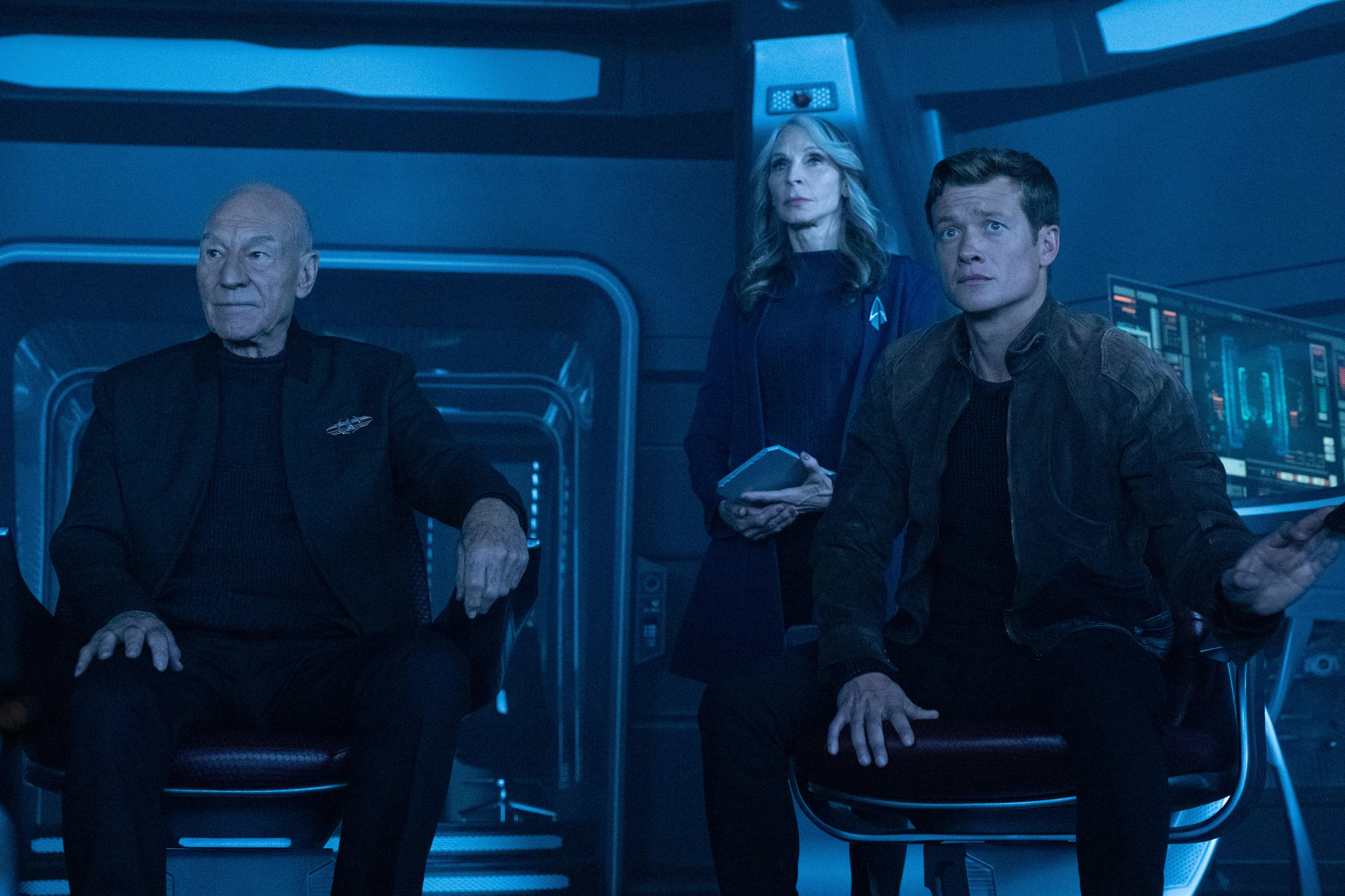 Jean-Luc Picard and Jack Crusher sit on the bridge of the Titan and look ahead as Beverly Crusher stands behind and between them