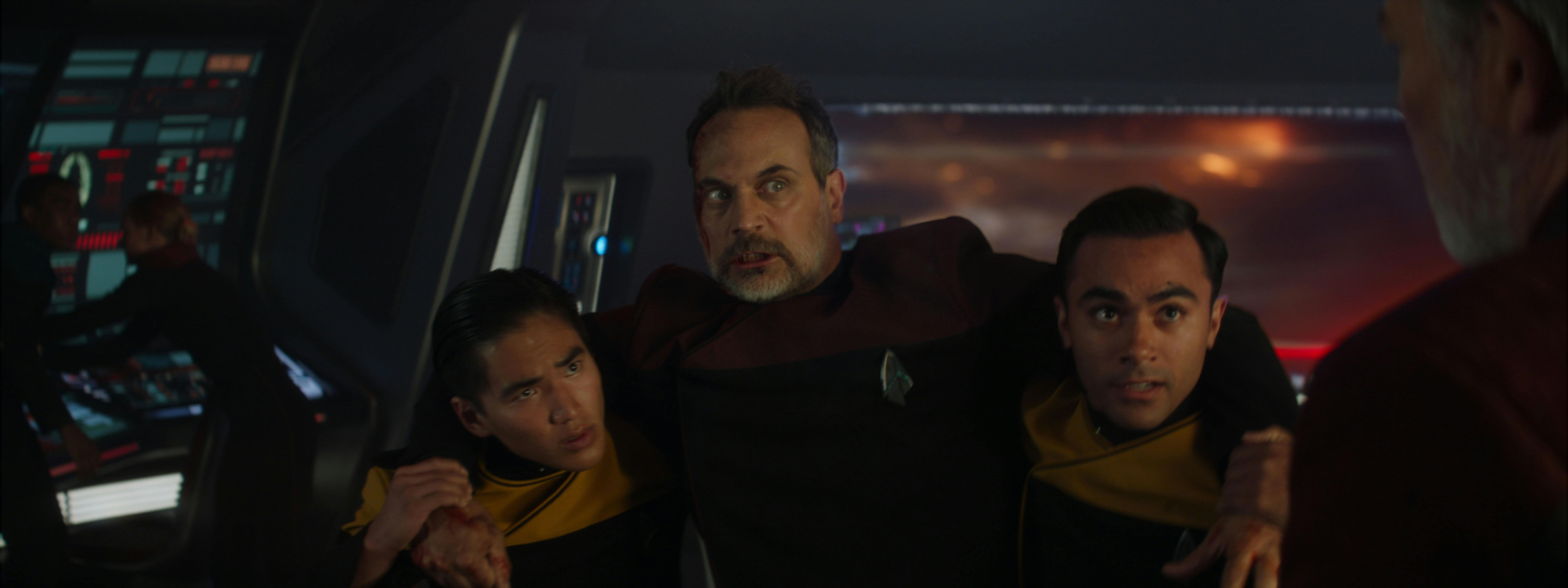 An injured Captain Liam Shaw is carried by two crewman on the bridge of the Titan in Star Trek: Picard