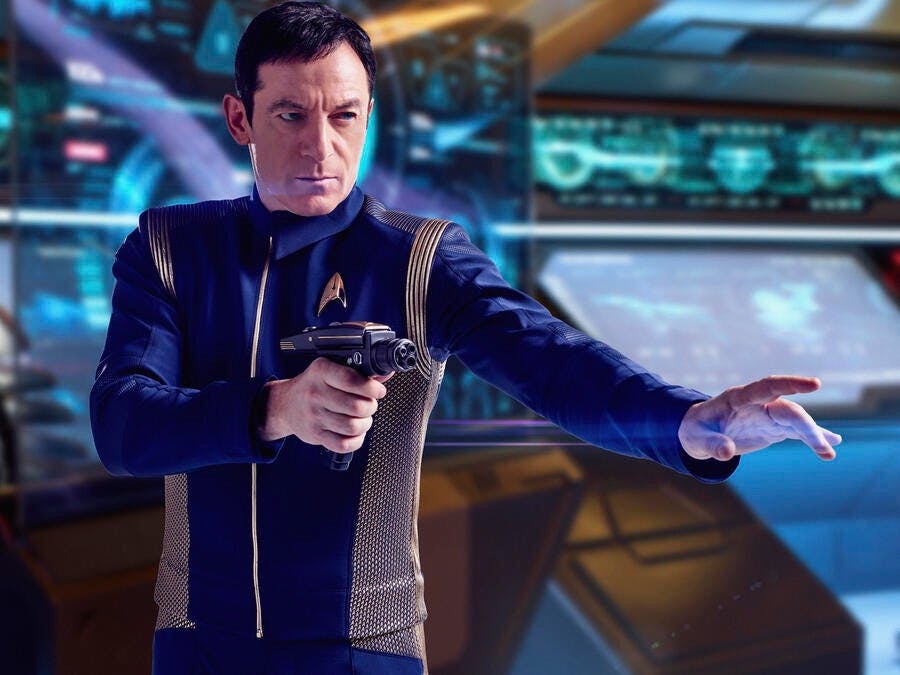 Jason Isaacs as Captain Gabriel Lorca holding his phaser in a defensive stance in a Star Trek: Discovery Season 1 gallery photo